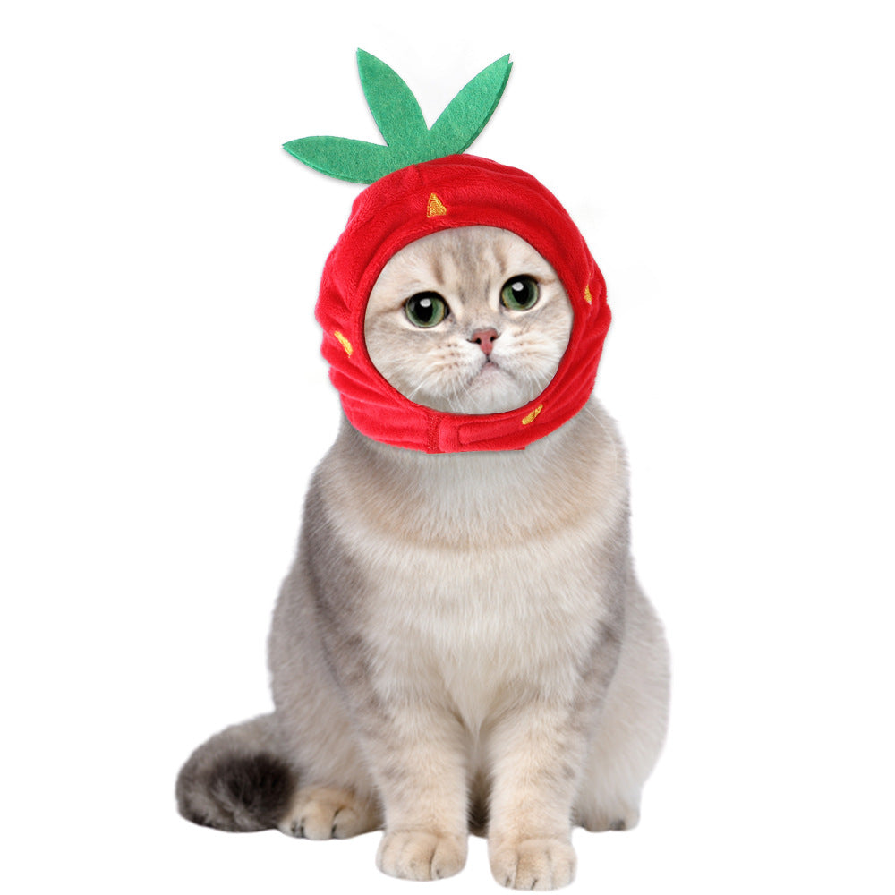 Red plush fruit pet hat with green leaf top accents and a face opening