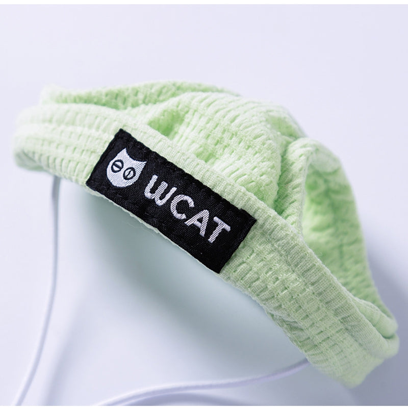 Light green two-legged pet shirt with hood and black U C A T label
