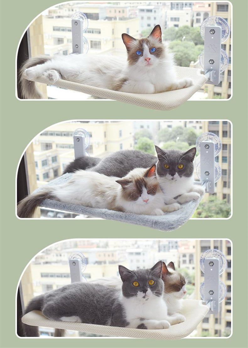 Window glass cat hammock with suction cups, showing grey and white cats on fabric pads