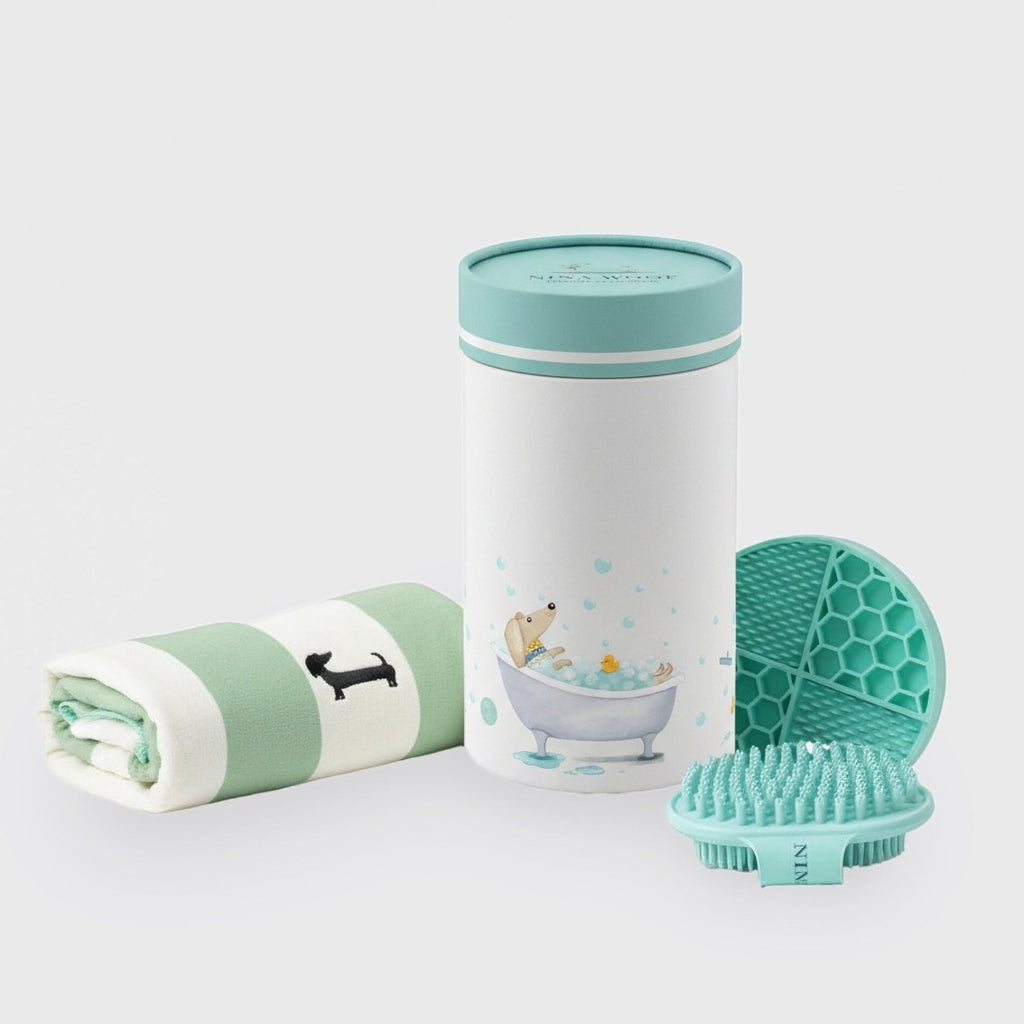 Mint and white dog bath kit container, rolled towel, and teal silicone brush