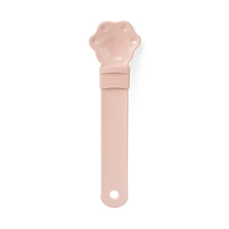 Cat treat spoon squeeze with cat-shaped head, pink handle