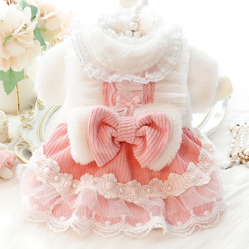 Small pet dress in pink and white with lace trim collar and large bow at the waist
