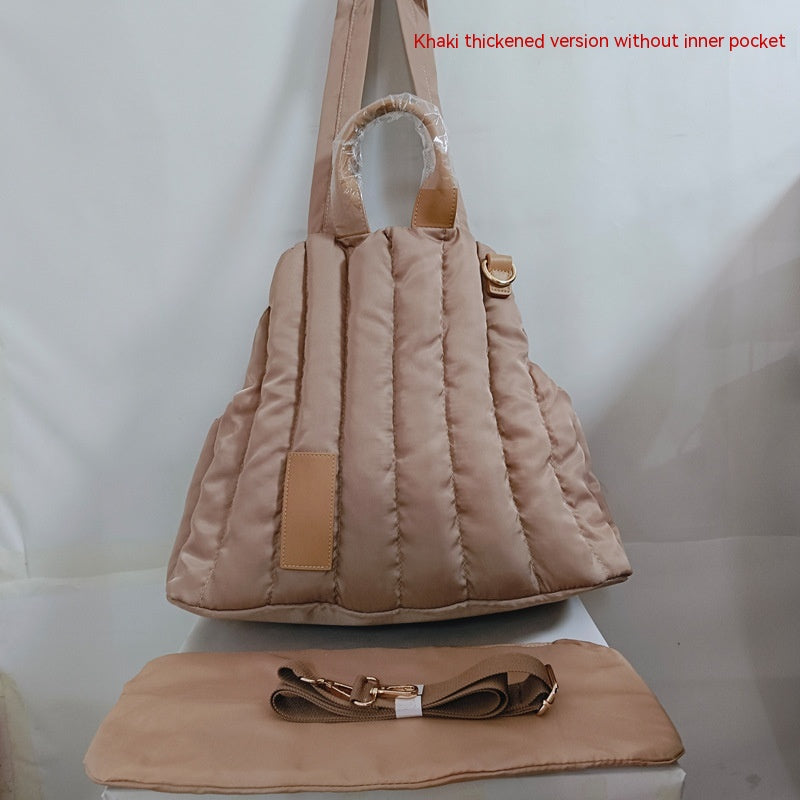 Khaki quilted pet shoulder bag with beige fleece hood and tan handle accents
