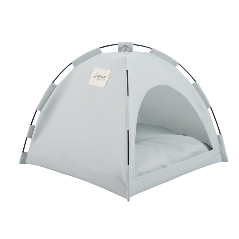 White fabric pet tent with arched doorway and padded interior cushion, freestanding