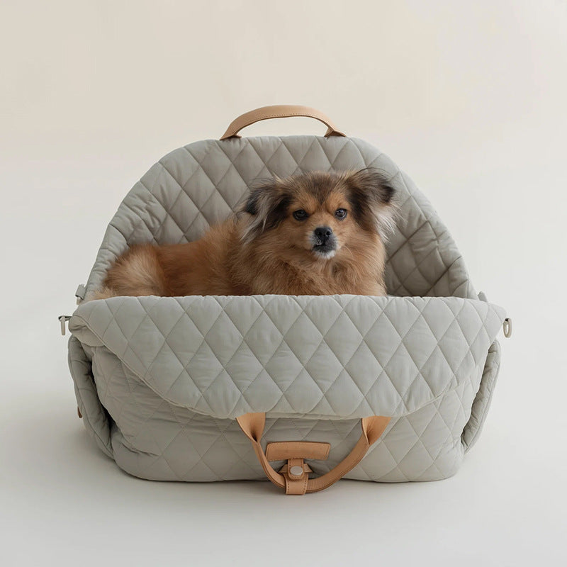 Quilted light gray pet handbag with tan base strap and side zipper tabs