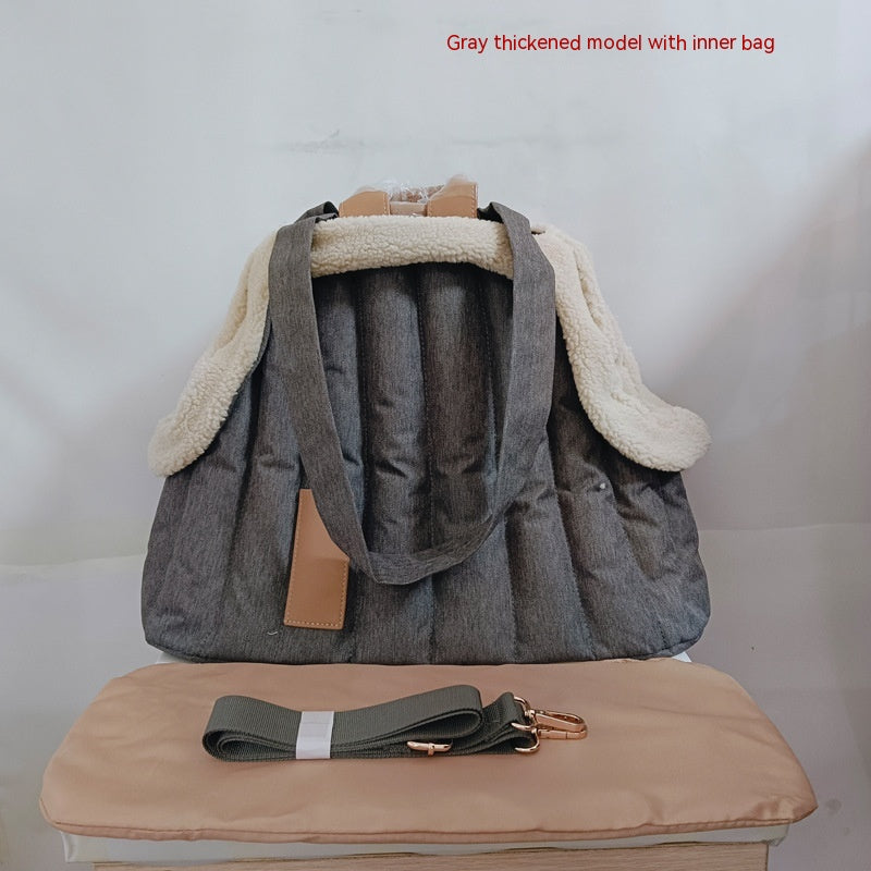 Gray quilted pet shoulder bag with beige fleece hood and brown handle strap