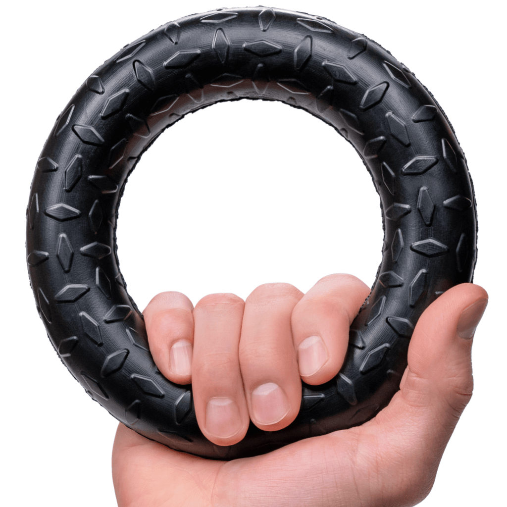 Black rubber chew ring toy with knobby tread texture and finger grip center.