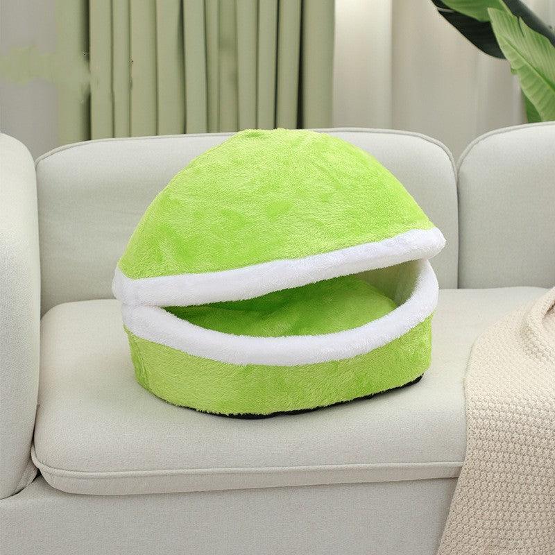 Green plush pet nest with white inner rim, round dome shape