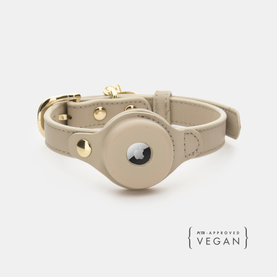 Beige vegan leather dog collar with AirTag holder and gold hardware, snap closure