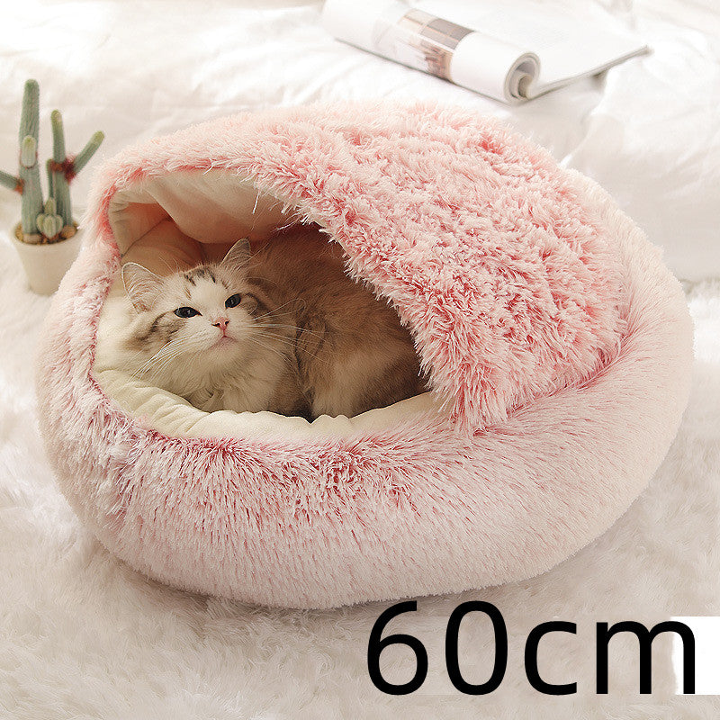 Pink shag plush pet bed, round with open center and raised fuzzy rim; cat inside