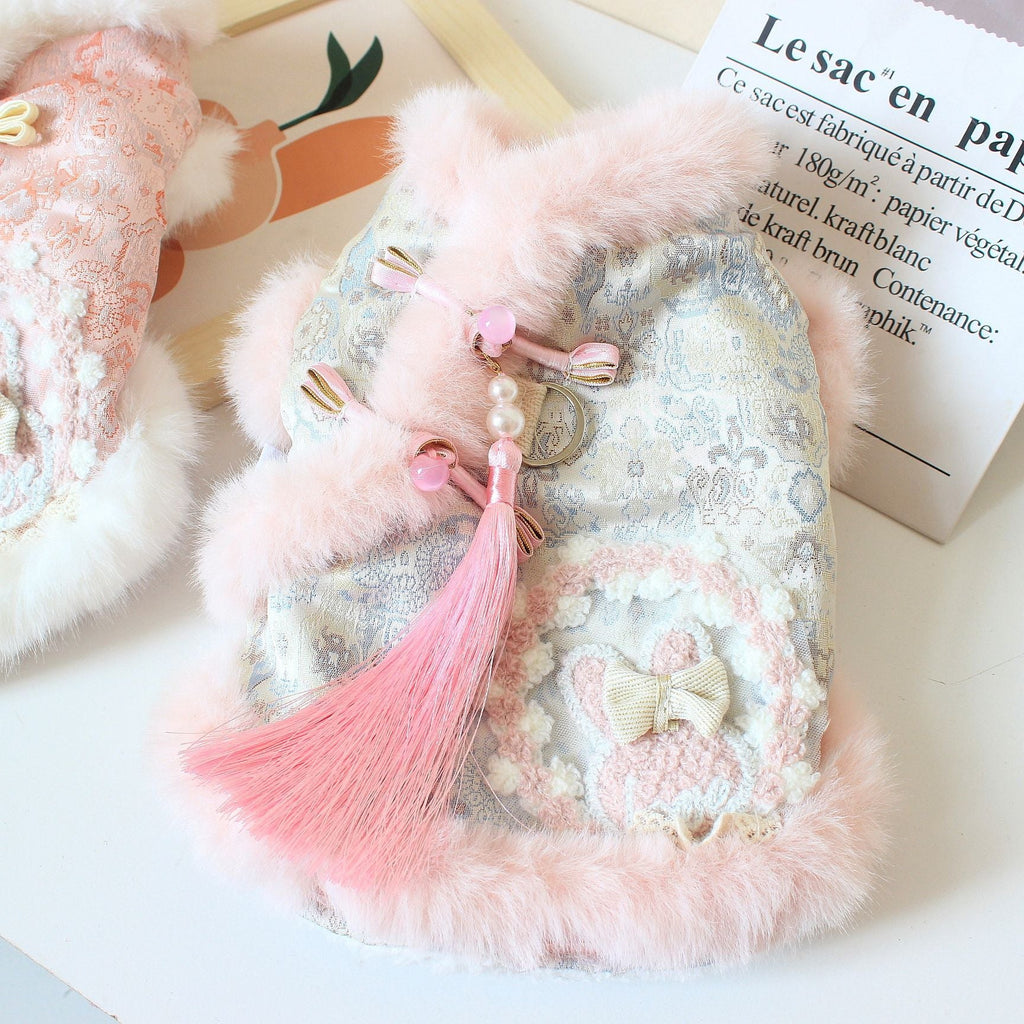 Pink patterned pet jacket with white faux-fur trim, tassel charms and bow ties