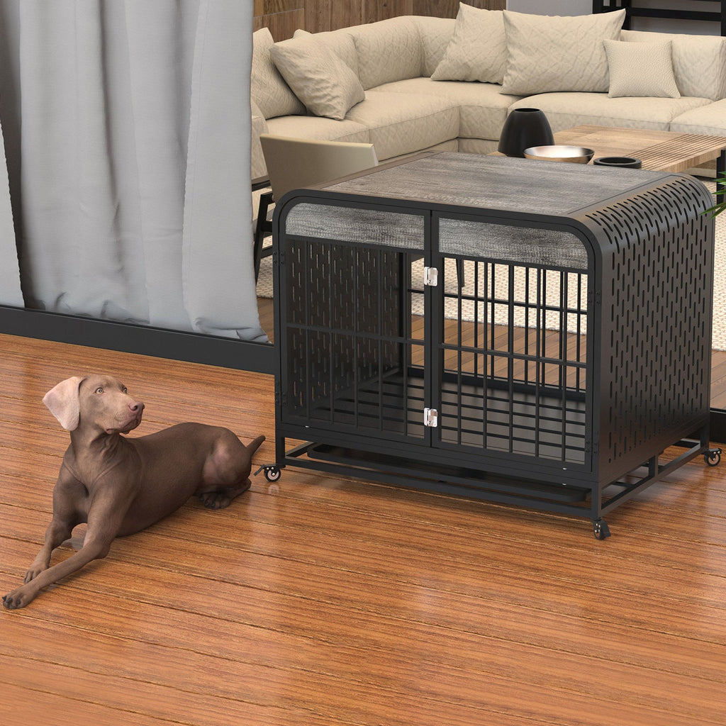 Grey dog crate table with barred front door and black perforated sides, rolling wheels; light gray dog