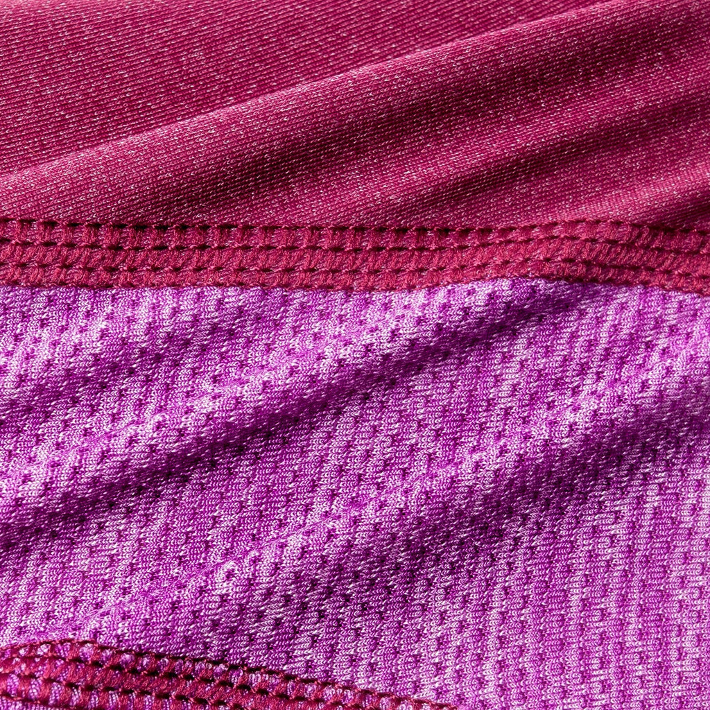 Pink dog hoodie fabric close-up with stitched seam detail