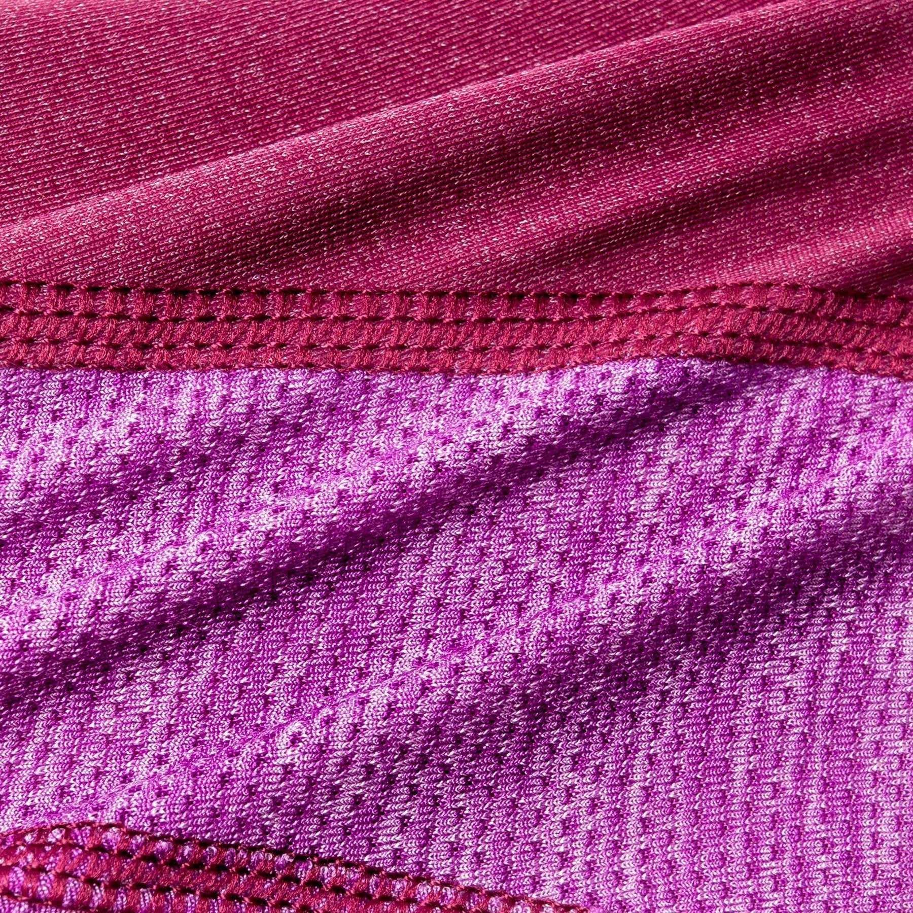 Pink dog hoodie fabric close-up with stitched seam detail