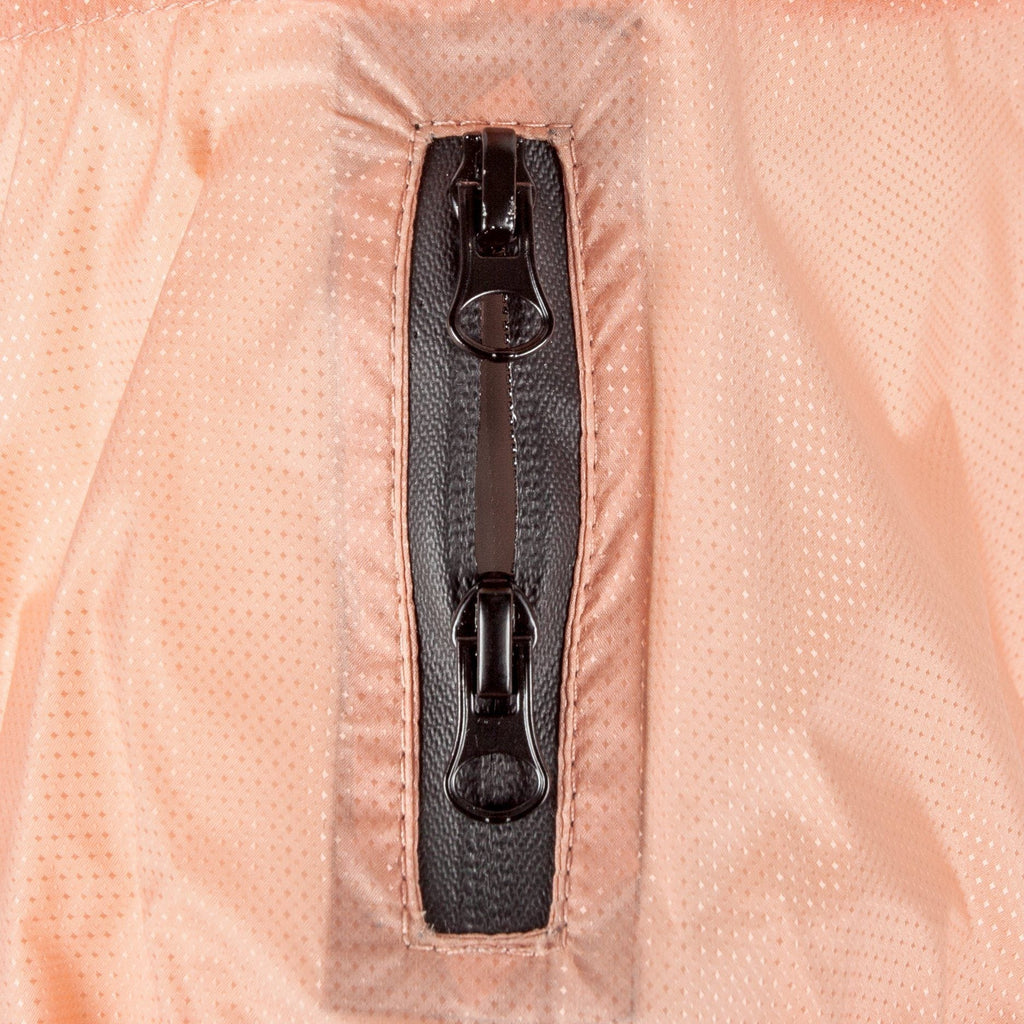 Close-up of peach raincoat poncho zipper with two black pull tabs