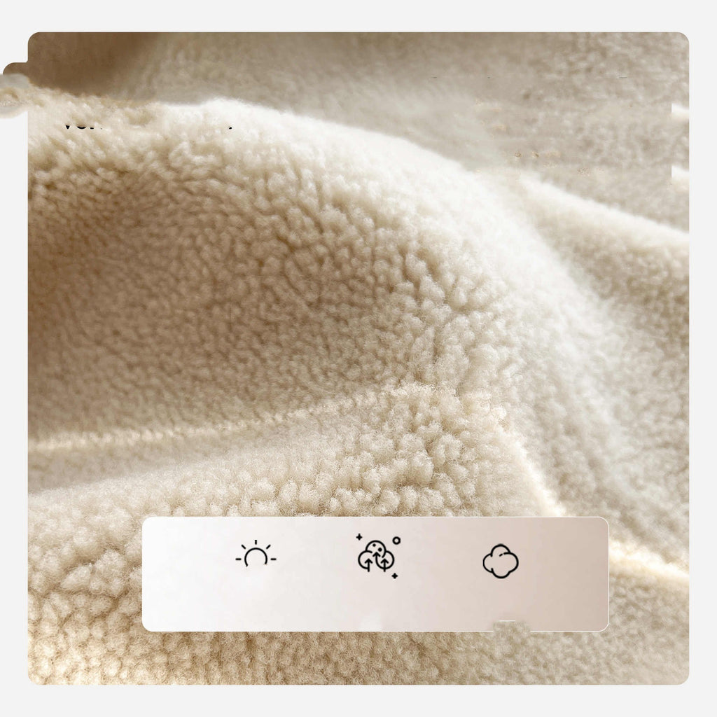 Cream sherpa lining close-up with textured fabric and stitched trim on a jacket