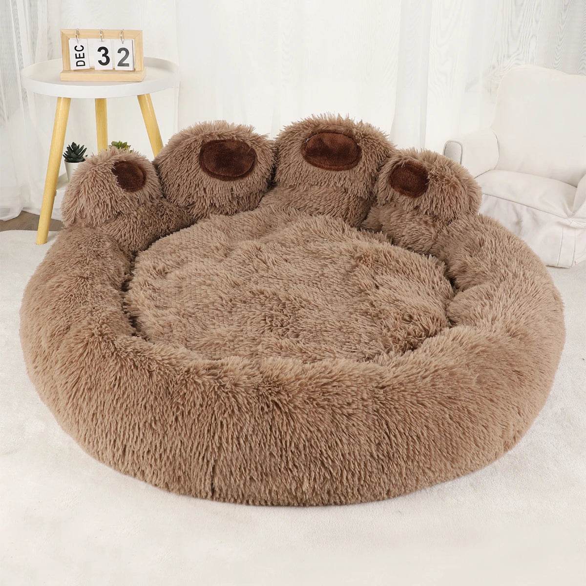 Brown plush pet sofa bed with three paw bolsters and wide round cushion base