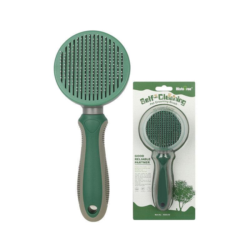 Green self-cleaning pet grooming brush with round needle head and handle (packaging)