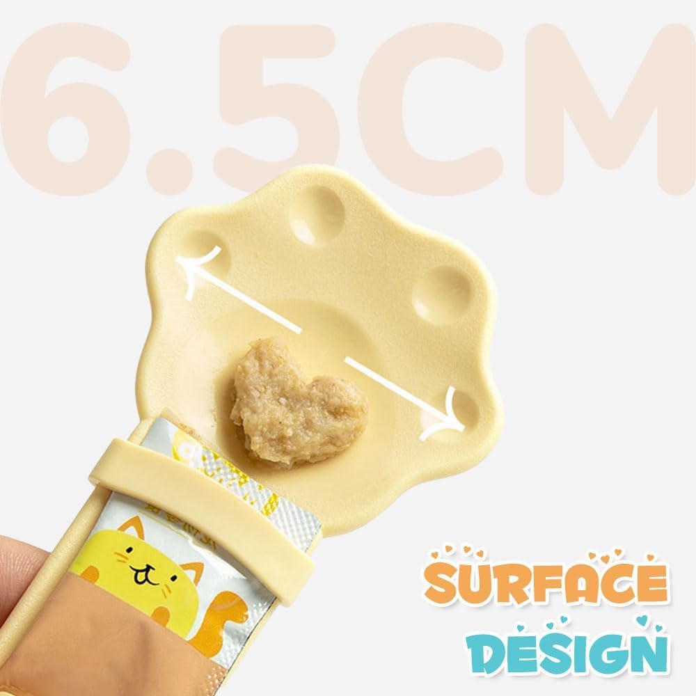 Yellow cat treat squeeze spoon with paw-shaped tip and handle, holding cat treat