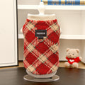 Plaid polar fleece dog jacket with leash ring, red-and-cream diamond check pattern.