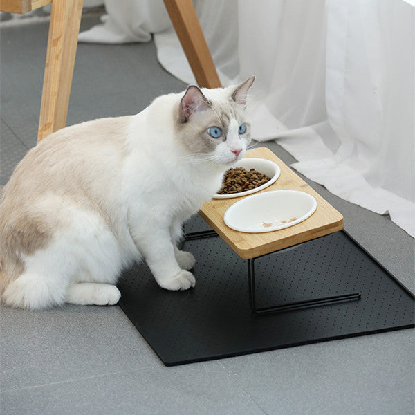 White ceramic cat water bowl on black stand, with a small feeding dish