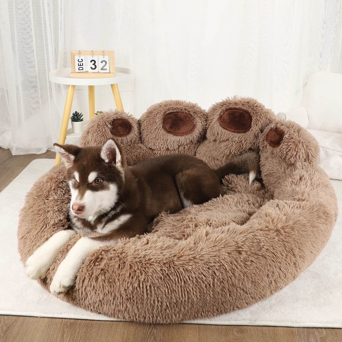 Brown plush pet sofa bed with three paw-shaped raised bolsters and shaggy center