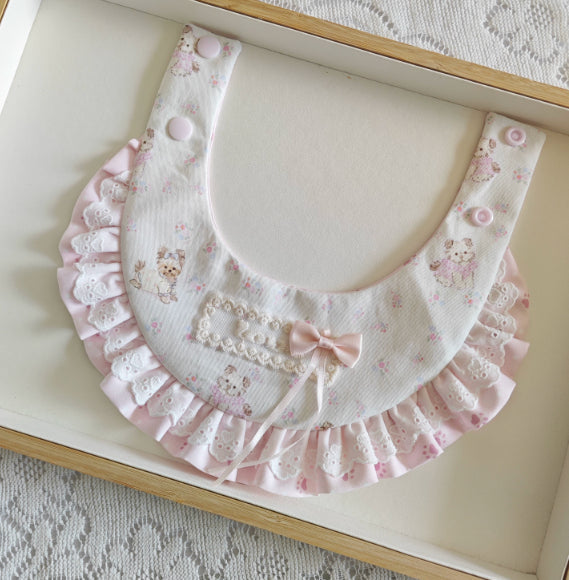 Pink lace-trimmed scarf with U-shaped neck opening, bow detail and teddy print