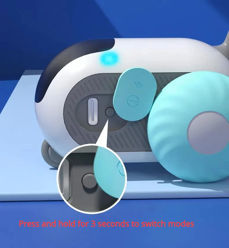 Close-up of white and black automatic cat car toy mode area with blue indicator light