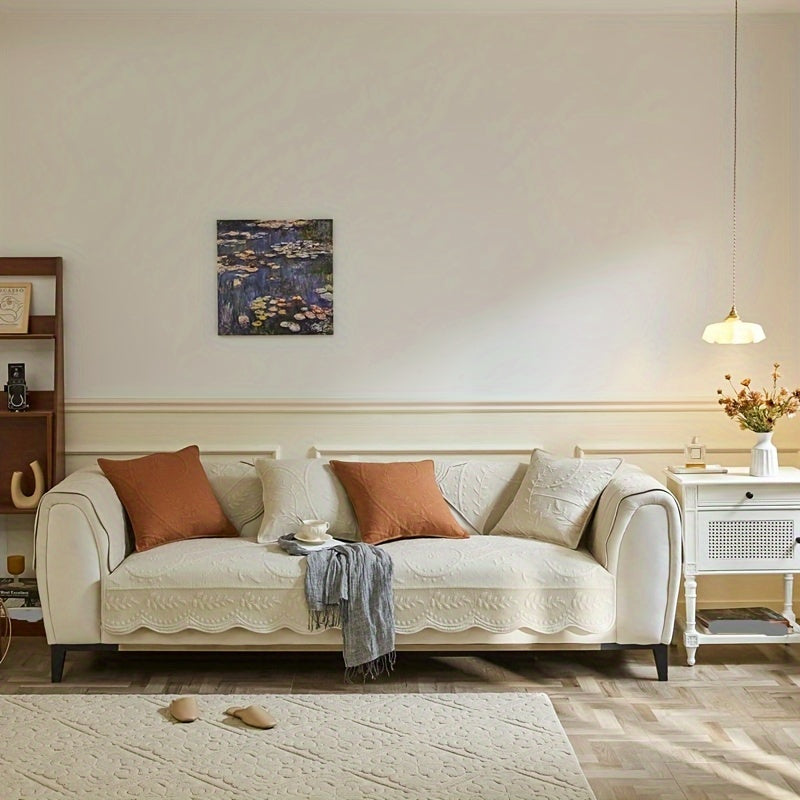 Beige yellow waterproof sofa cover with scalloped trim over sofa back and seat