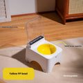 Automatic pet food feeder with open clear cover and yellow PP bowl, white base