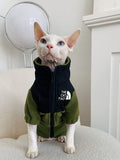 Olive green fleece cat jacket with zipper and hood, front 'THE CAT FACE' chest patch.