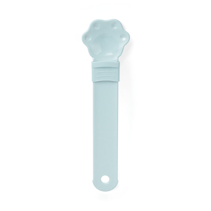 Cat treat spoon squeeze with cat-shaped head, light blue handle