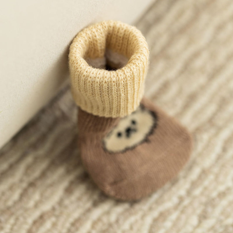 Single brown dog sock with a white bear knit patch and ribbed ankle cuff