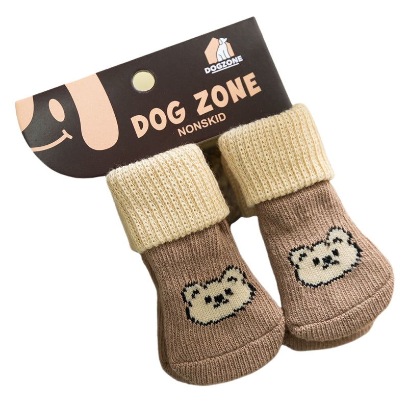 Pair of knit dog socks, tan and brown with smiling bear face patches and ribbed cuffs.
