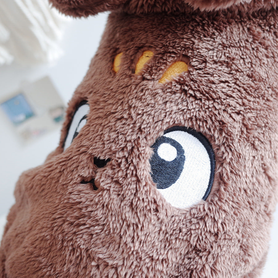 Close-up of brown plush pet hooded vest fabric with embroidered cartoon face