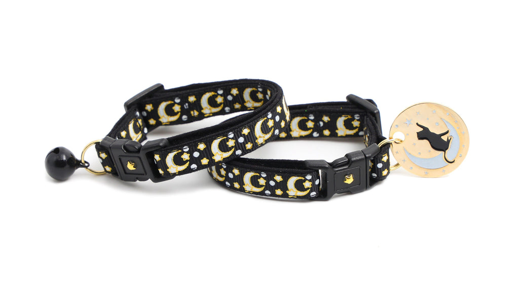 Black cat collar with gold moons and stars pattern, buckle detail, and oval cat charm