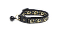 Black cat collar with gold moons and stars pattern and black bell
