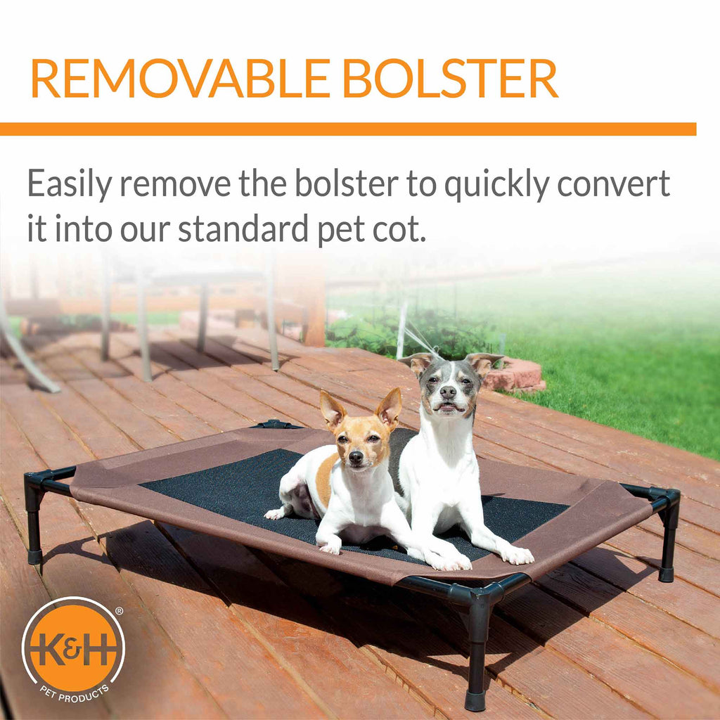 K&H pet cot base with dark mesh center on a wooden deck, no bolsters installed
