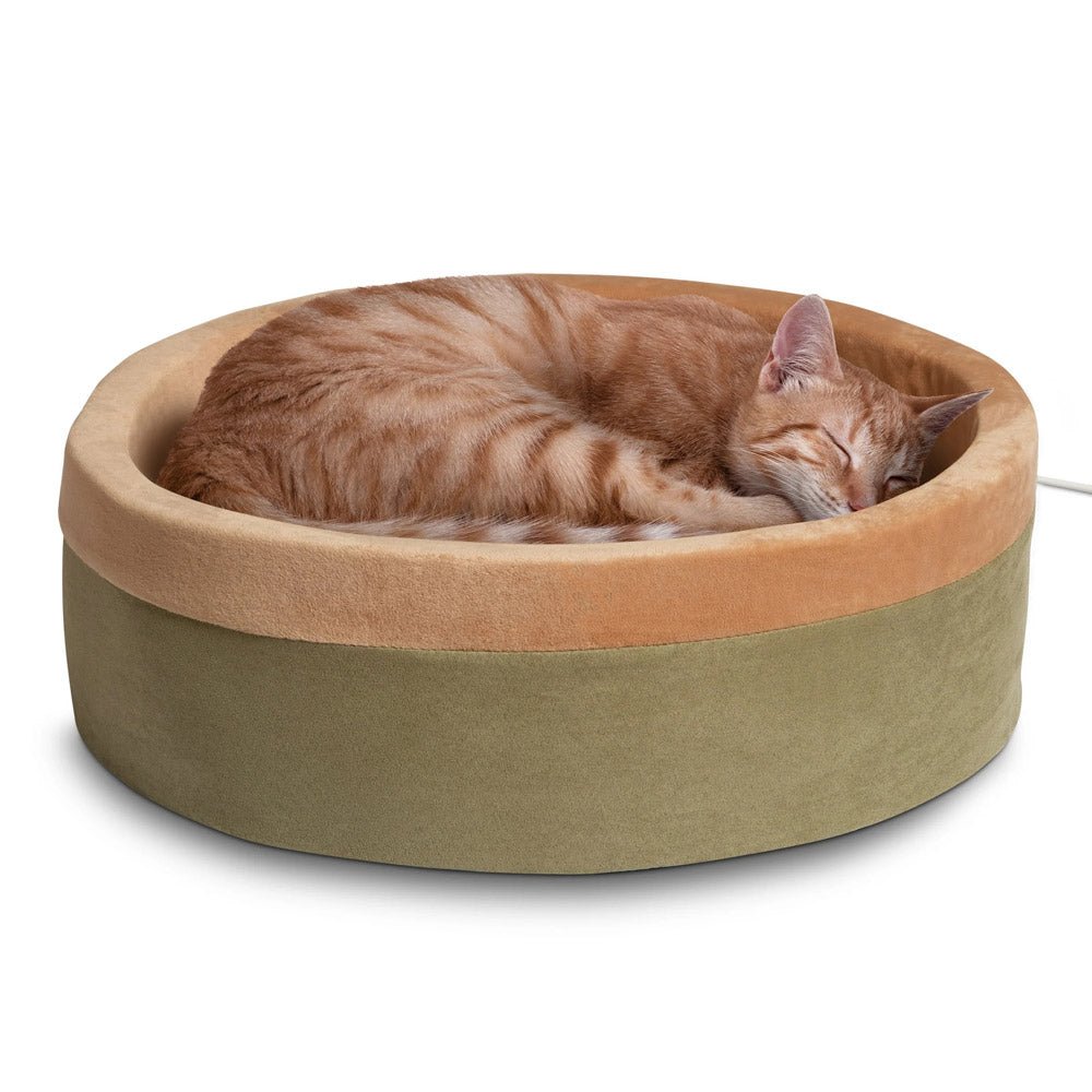 Heated cat bed with light tan outer fabric and beige interior cushion, with orange cat sleeping