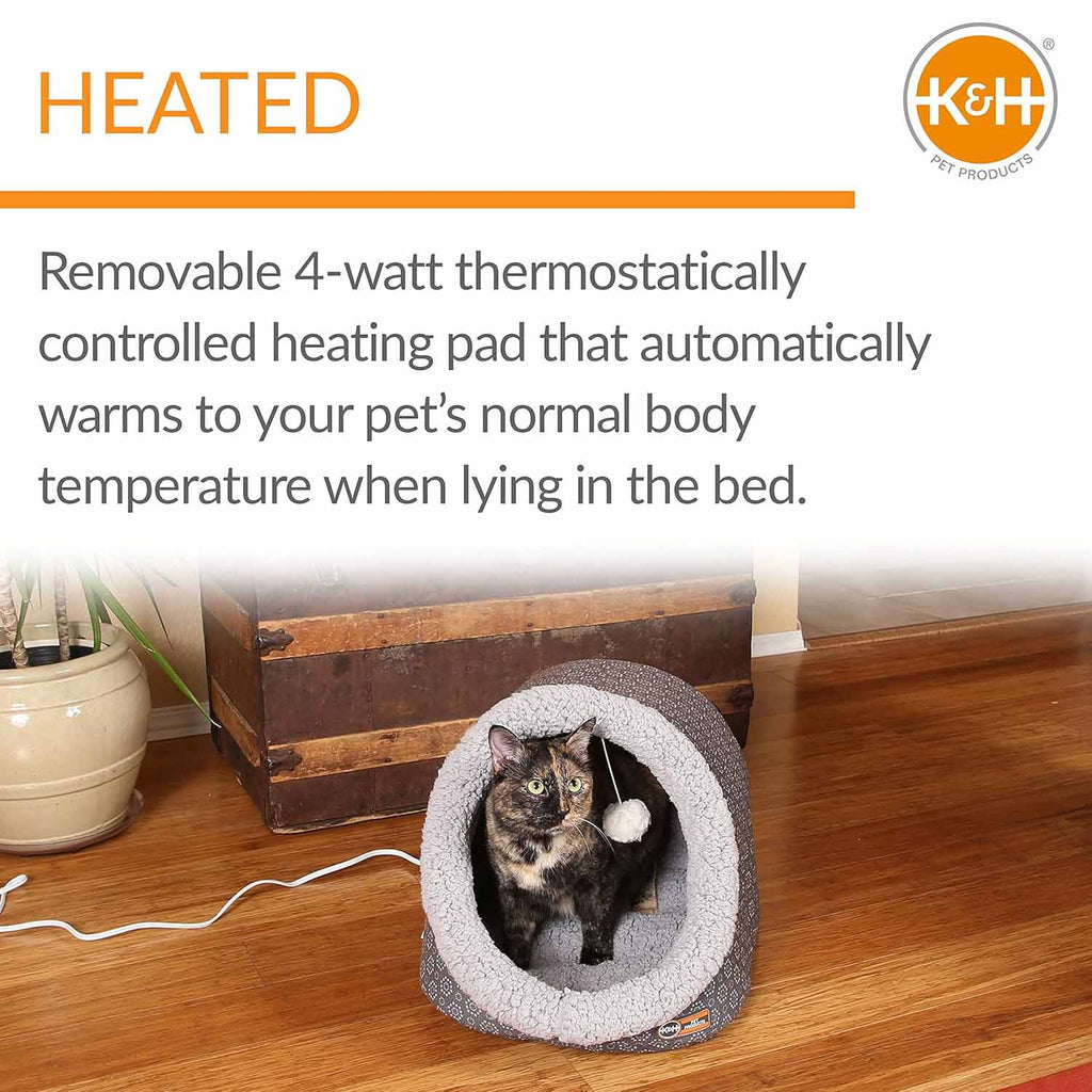 Heated plush cat cave bed with grey tunnel lining and dark shell, white-and-grey cat inside