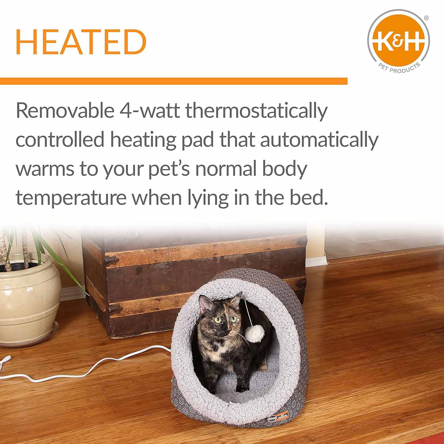 Heated plush cat cave bed with grey tunnel lining and dark shell, white-and-grey cat inside