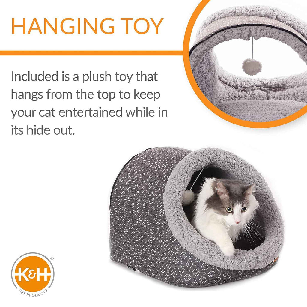 Heated plush cat cave bed with hanging toy ball above tunnel opening, grey lining