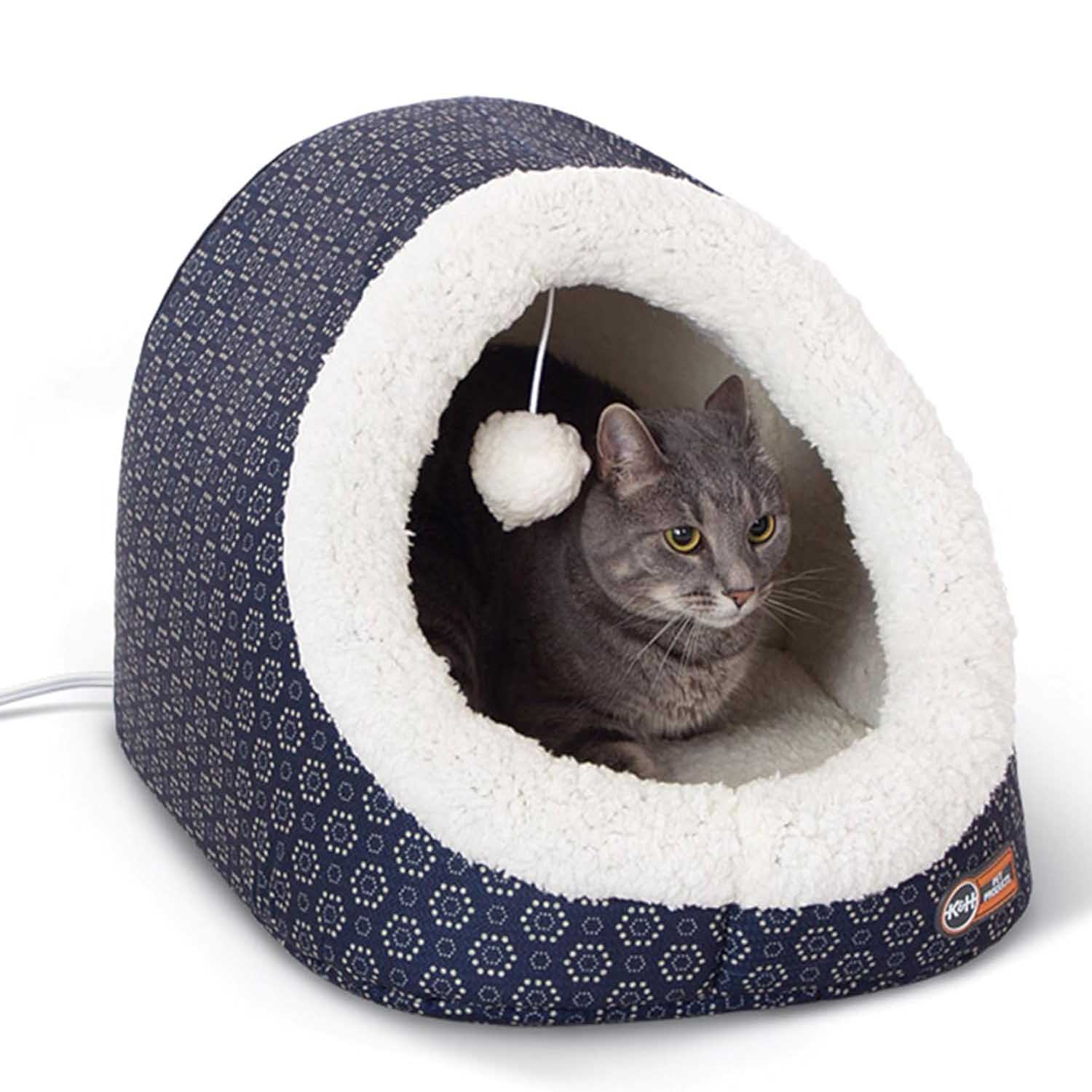 Heated plush cat cave bed in dark blue pattern with white tunnel lining, grey cat inside