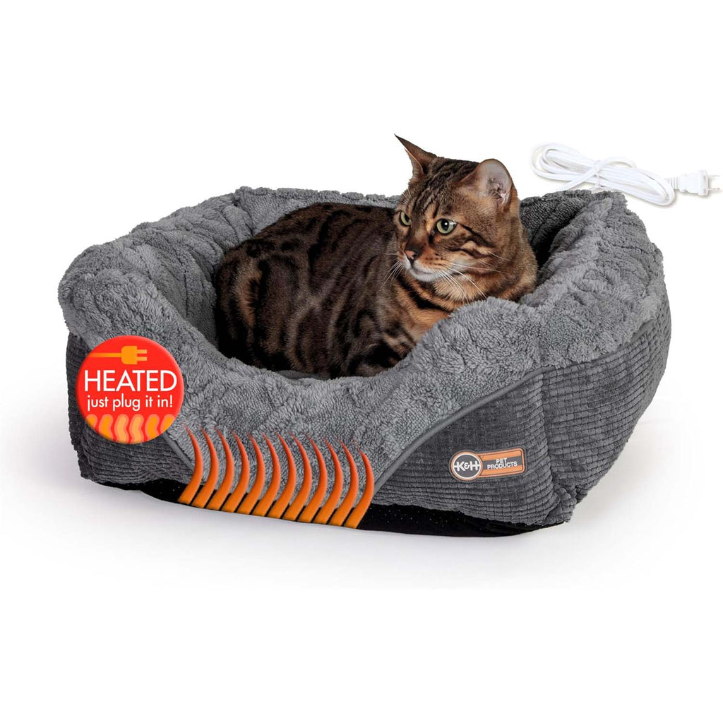 Grey plush heated cat and small dog bed with curled bolsters; cat resting inside