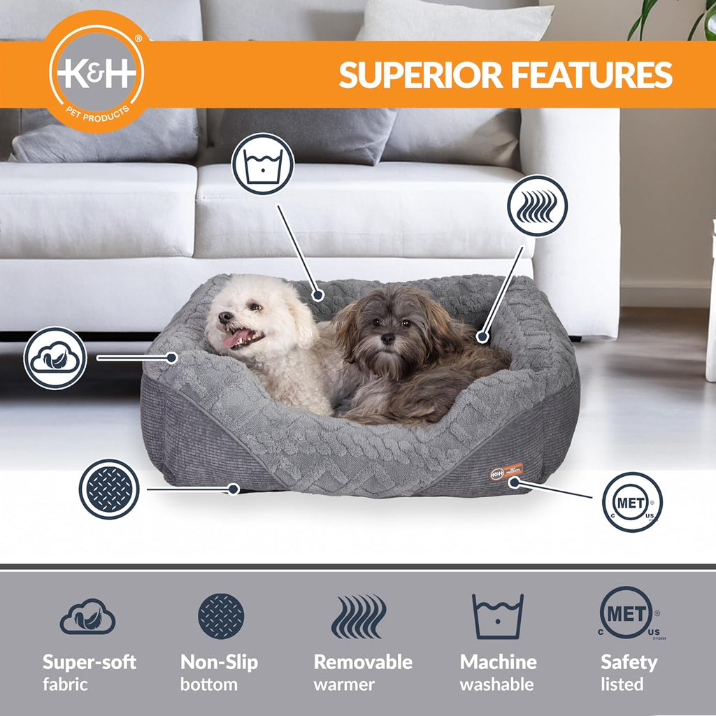 Grey plush heated pet bed with raised sides; two small dogs lying together