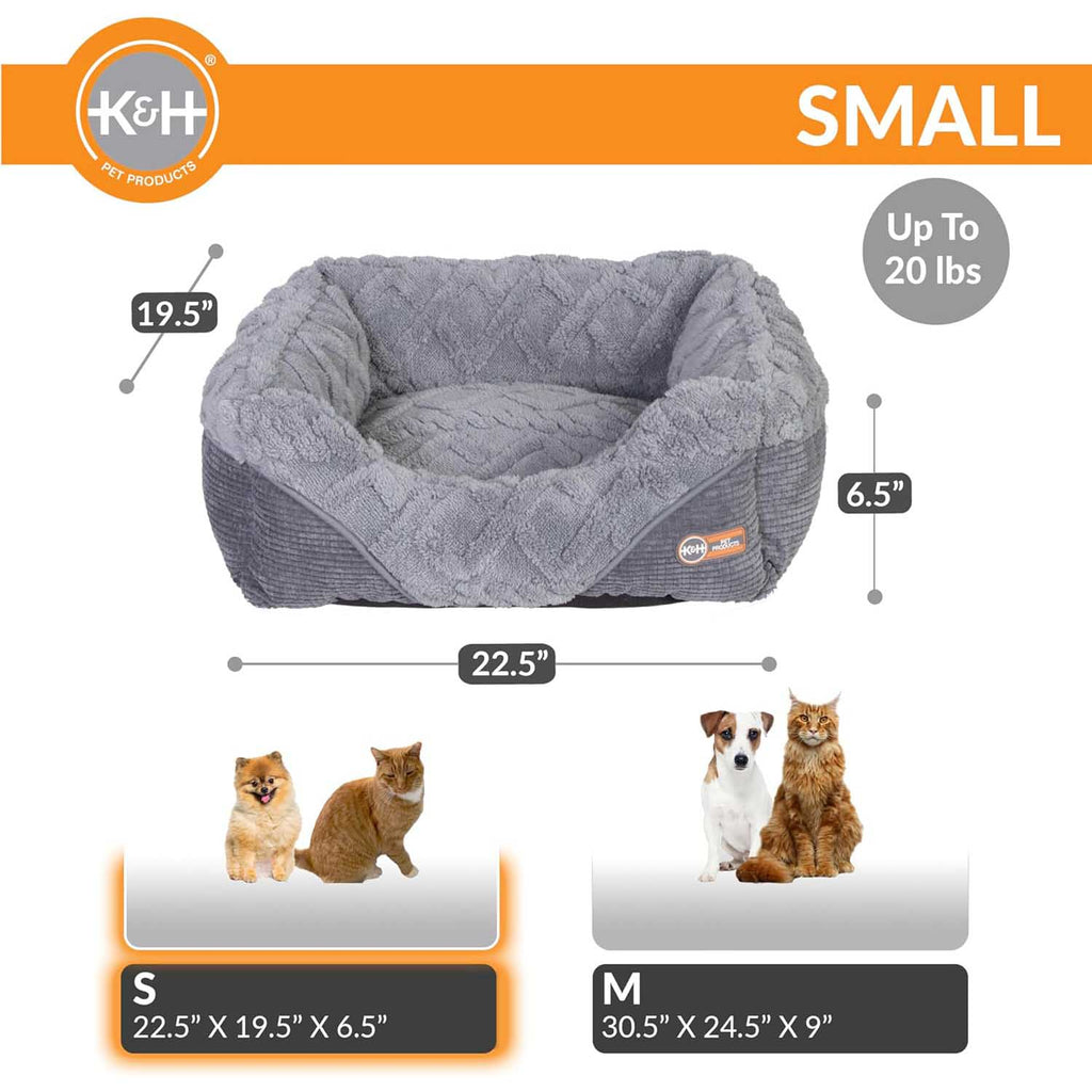 Grey plush heated pet lounge bed with raised side bolsters and textured cushion