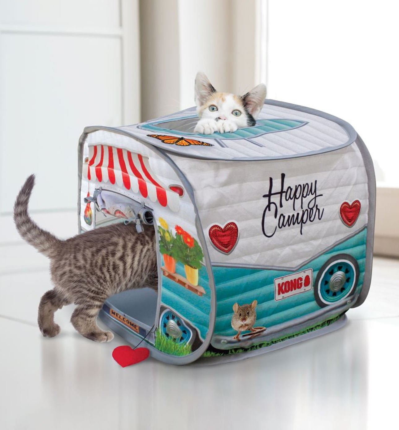 Cat pop-up camper toy with 'Happy Camper' hearts and KONG logo; cat playing