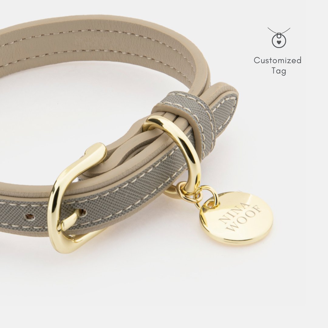 Grey vegan leather dog collar close-up with gold clasp and customized round tag