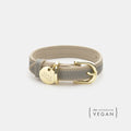 Grey vegan leather dog collar with gold buckle and round brand tag