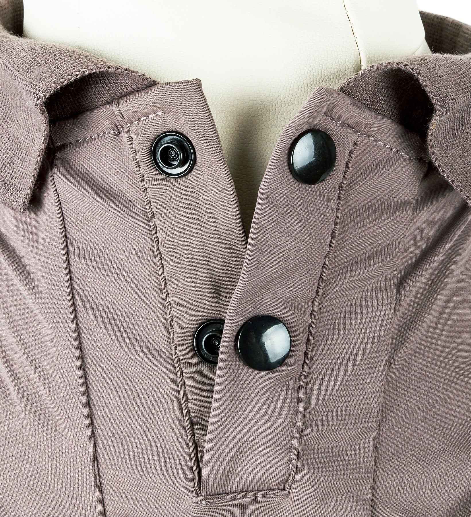 Brown dog polo close-up: snap-button placket and collar seam